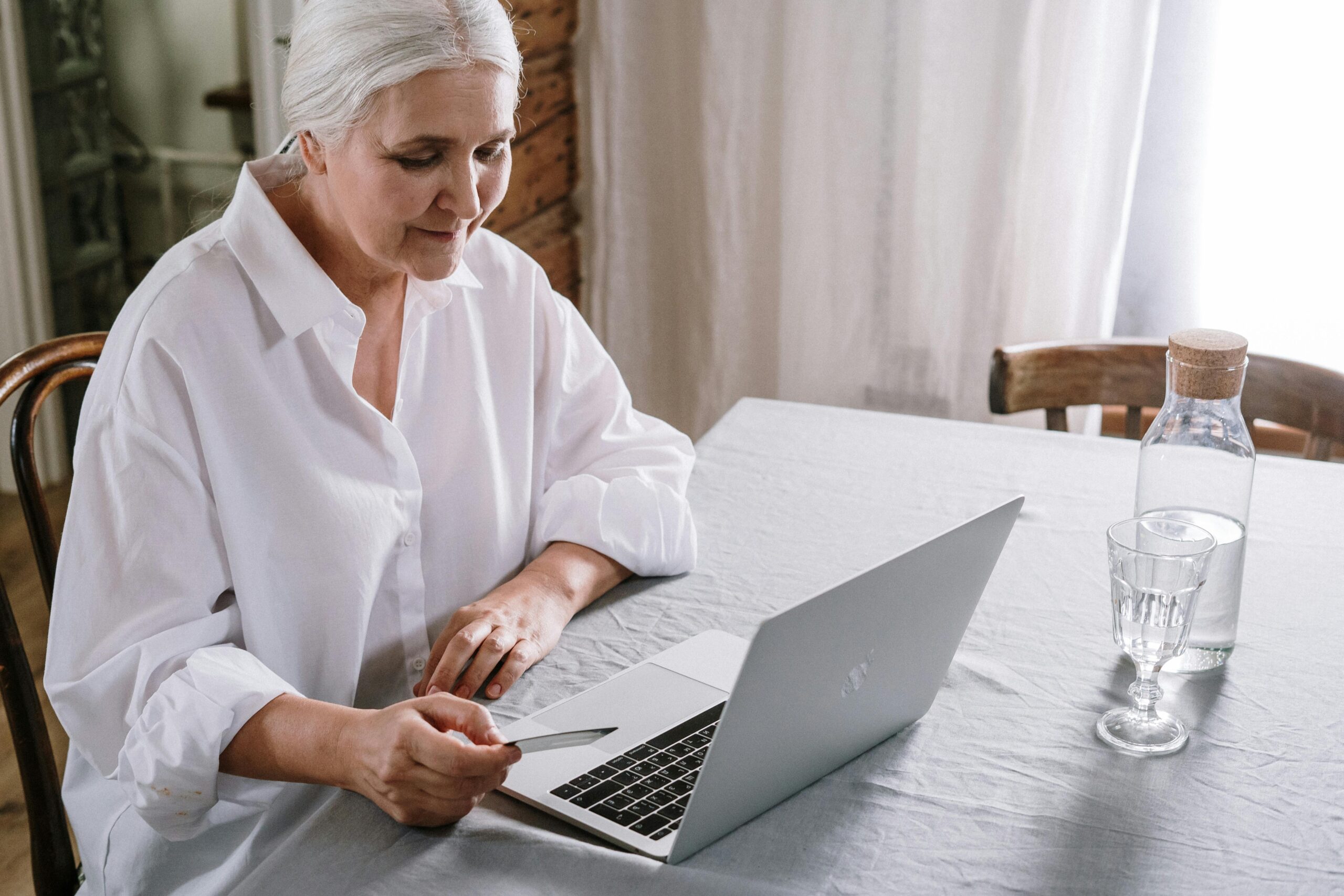 Lady at her computer researching what Medicare covers.